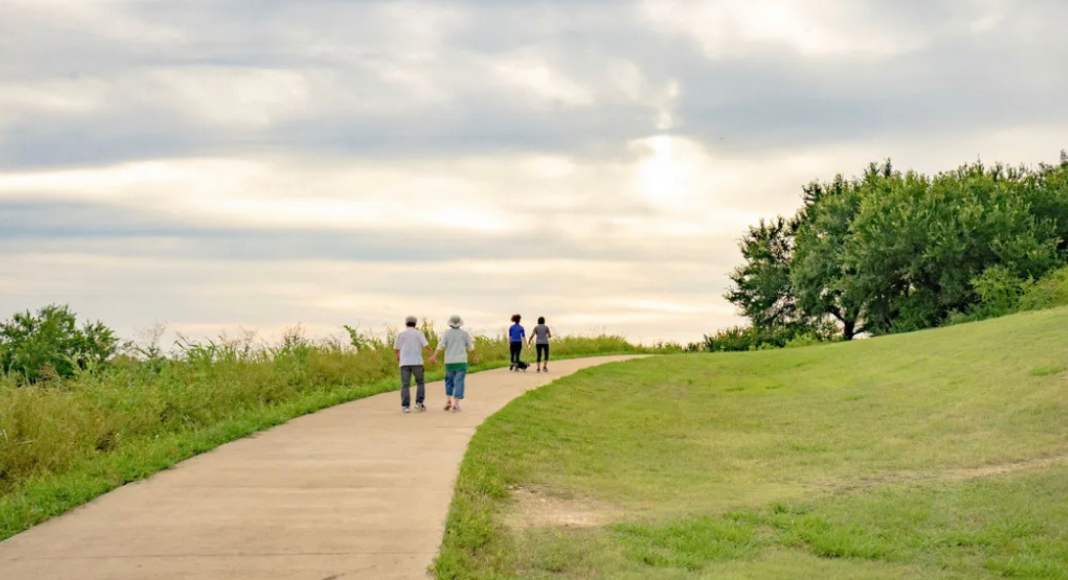 Paved trails in Collin County offer easy access for walkers of all ages and abilities, showcasing the natural beauty of the area.