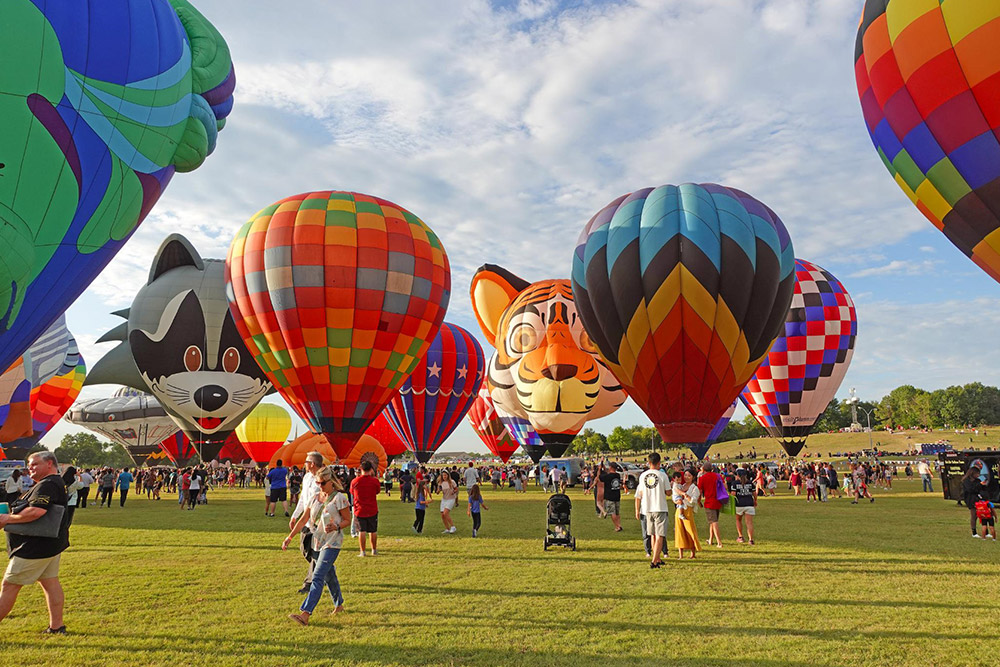 A vibrant display of hot air balloons fills the sky at the Plano Balloon Festival, embodying the spirit of this beloved local event.